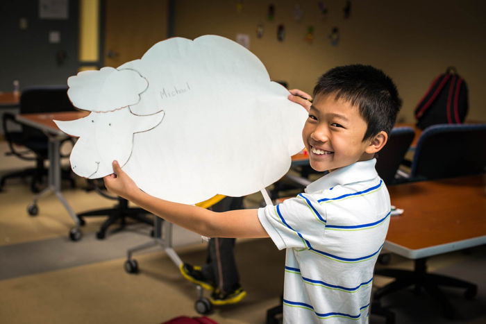 A boy holding his cloud artwork