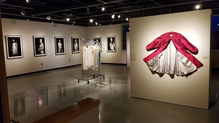 Art gallery featuring exhibit of photographs and clothing