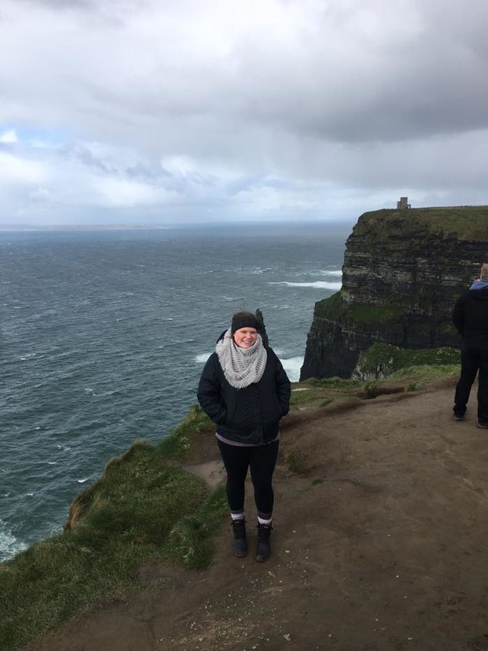 Student posing at Cliffs of Moher in Ireland