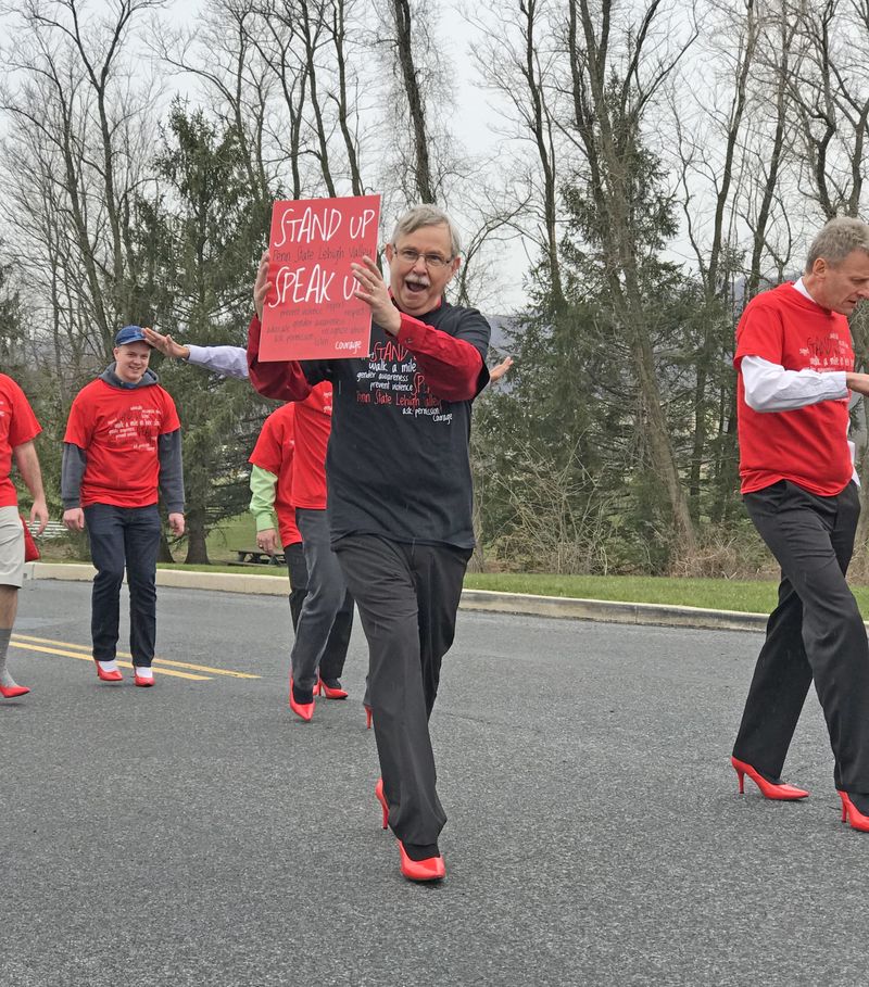 man in red heel holding sign 