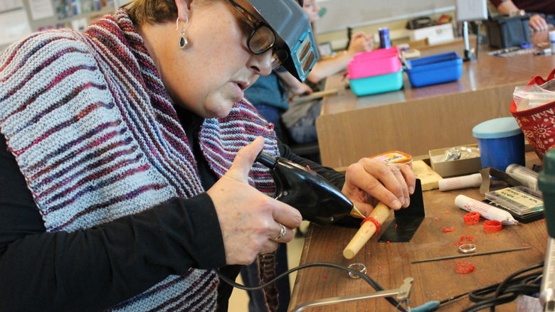 woman creating jewelry in a workshop