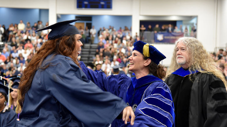 A Penn State Altoona graduate is congratulated by faculty