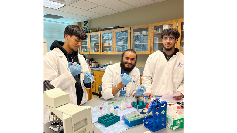 3 male biologists using lab equipment and smiling 