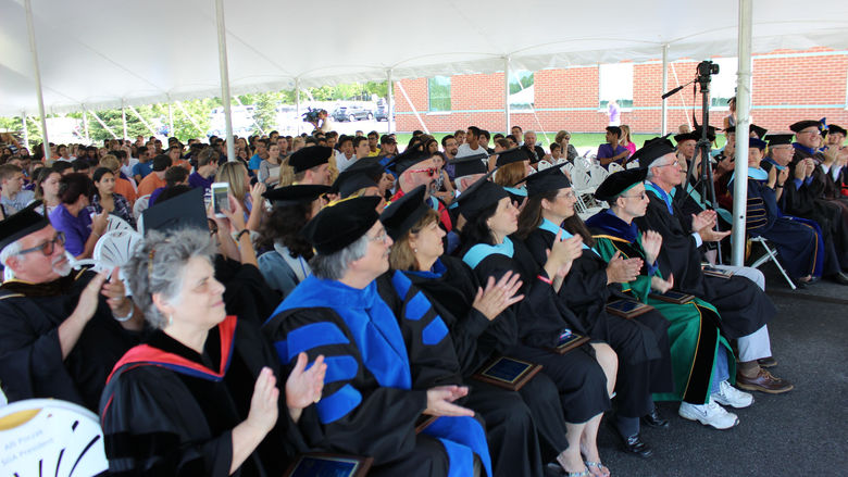 Group of faculty clap at convocation