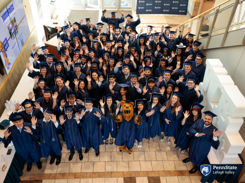 Penn State Lehigh Valley grads smile with the nittany lion on commencement day
