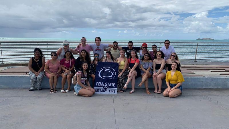 group of students and faculty in front of an ocean in Puerto Rico