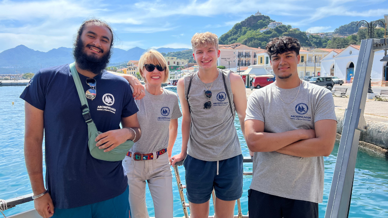 students smile in front of the Agean Sea in Greece