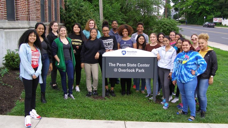 group of high school students by a sign