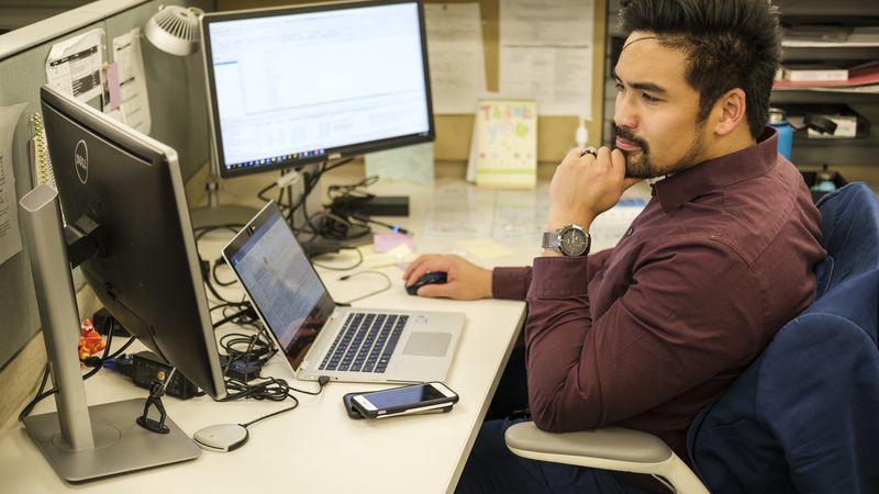 man looking at computer monitor