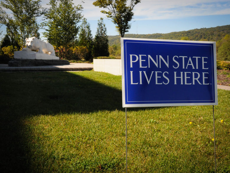 sign reading "penn state lives here" in the ground in front of the penn state lehigh valley nittany lion shrine