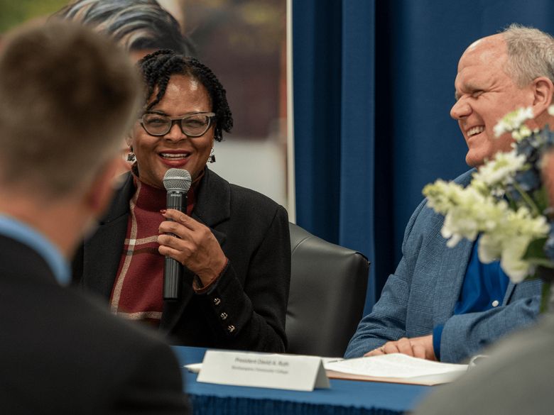 Dr. Richardson smiling talking to crowd 