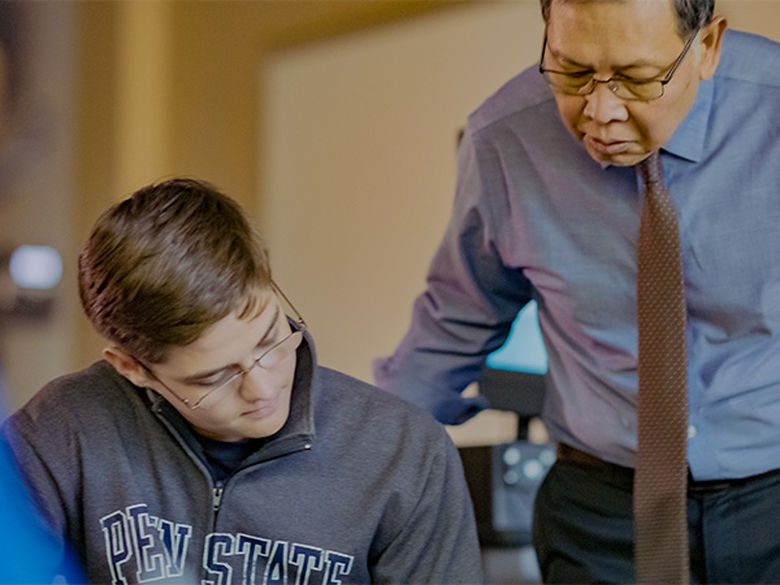 Dr. Min working with a student