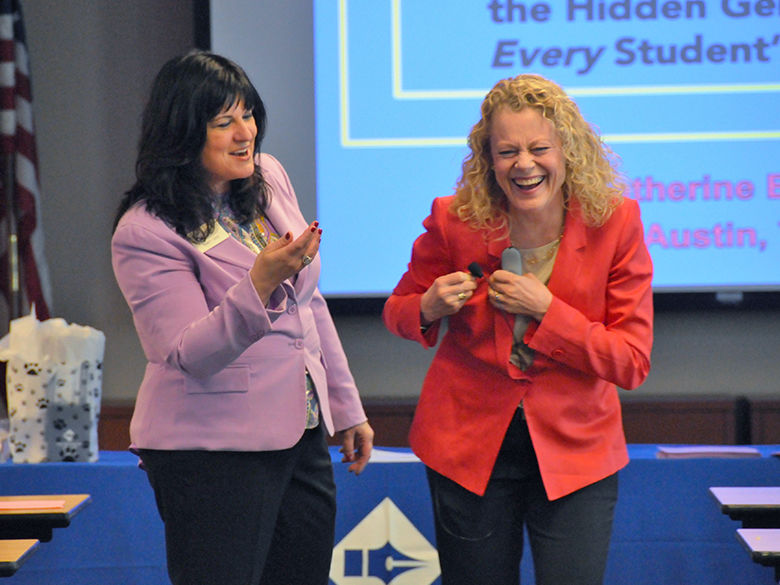 two professional development trainers are laughing together