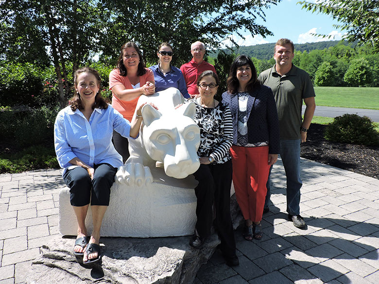 faculty and staff members posing with the nittany lion shrine