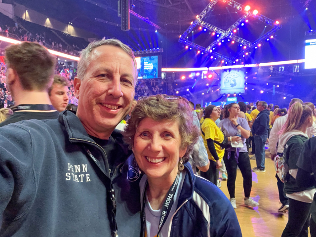 Bob Smyrl and Debbie Zuech-Smyrl on the floor among the dancers during THON 2023 at Penn State's Bryce Jordan Center. 