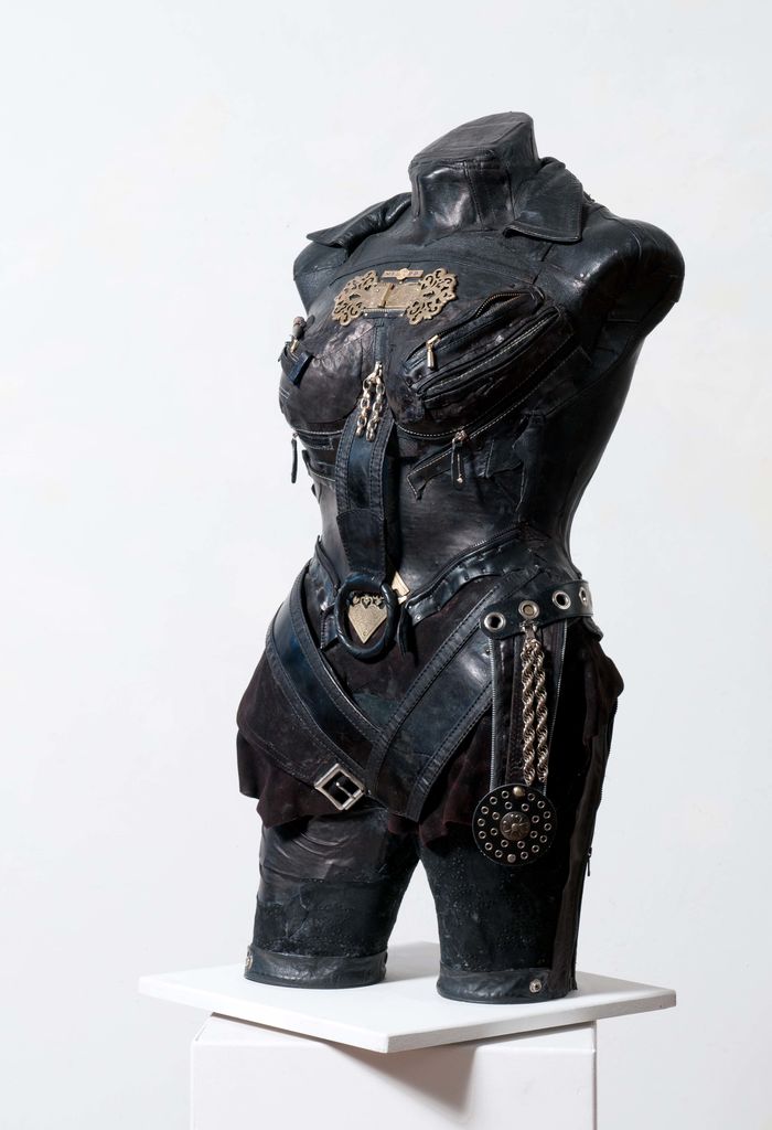Sculpture of a torso dressed in leather armour.
