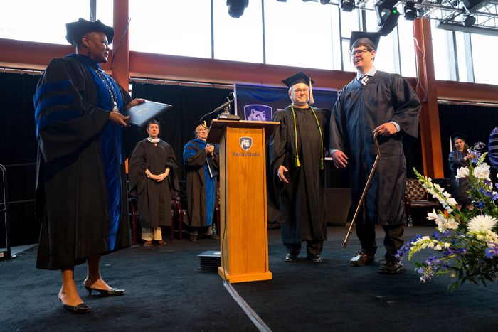 Graduate walking with cane to get his degree from Chancellor