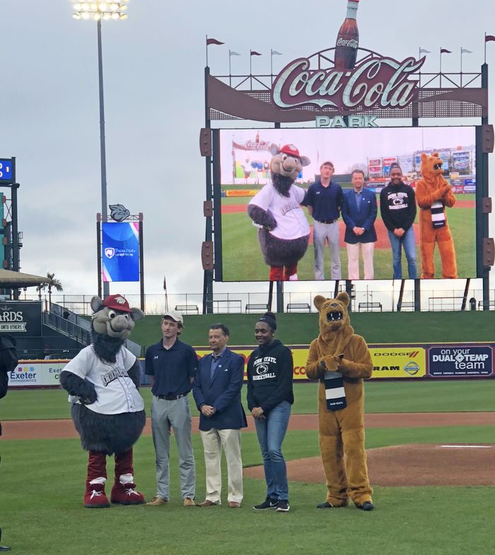 Nittany Lion on baseball field with students and FeRROUS, the IronPigs mascot 