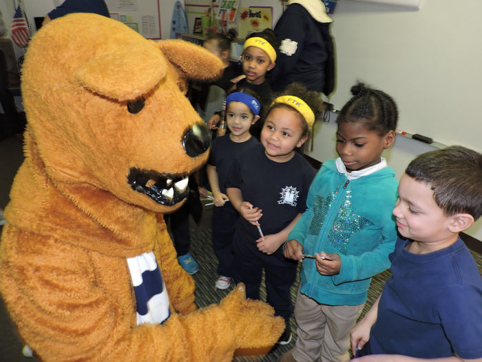 Students smile at Nittany Lion