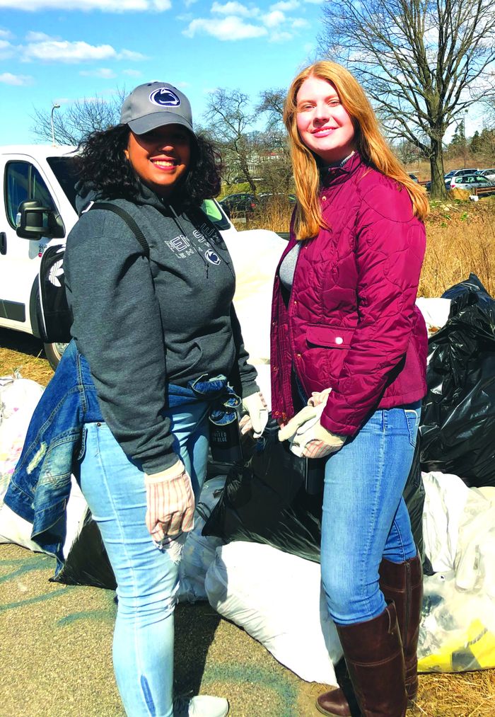 two women at a park clean up