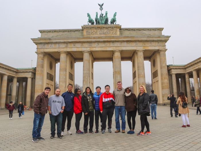 group of students and faculty in front of monument in Berlin