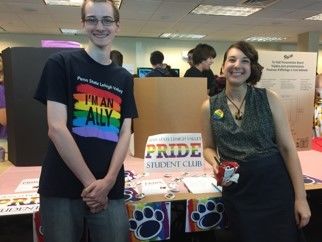 two  people at a station at an activities fair