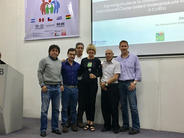 Dr. Jacqueline McLaughlin in the center with people from Bolivia at a presentation