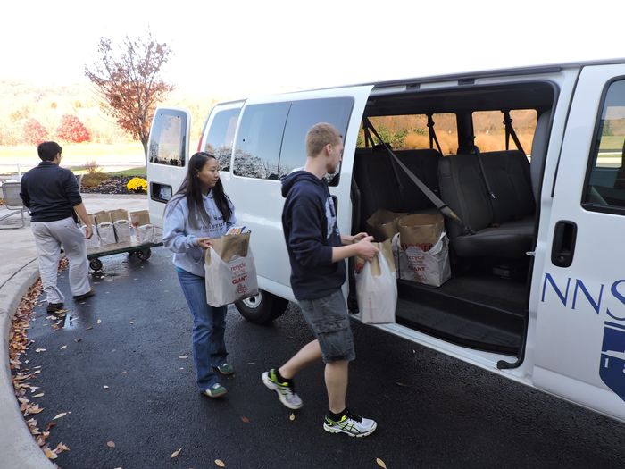Students load the van with food donations