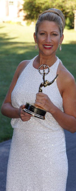 Woman holding an Emmy award