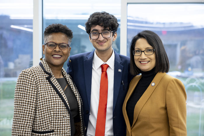 Dr. Richardson, Kriday Sharoma, and President Bendapudi stand together and smile at the camera.