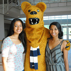 Two students and nittany lion
