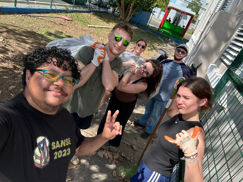 A group of students pause from clean-up efforts to pose for the camera