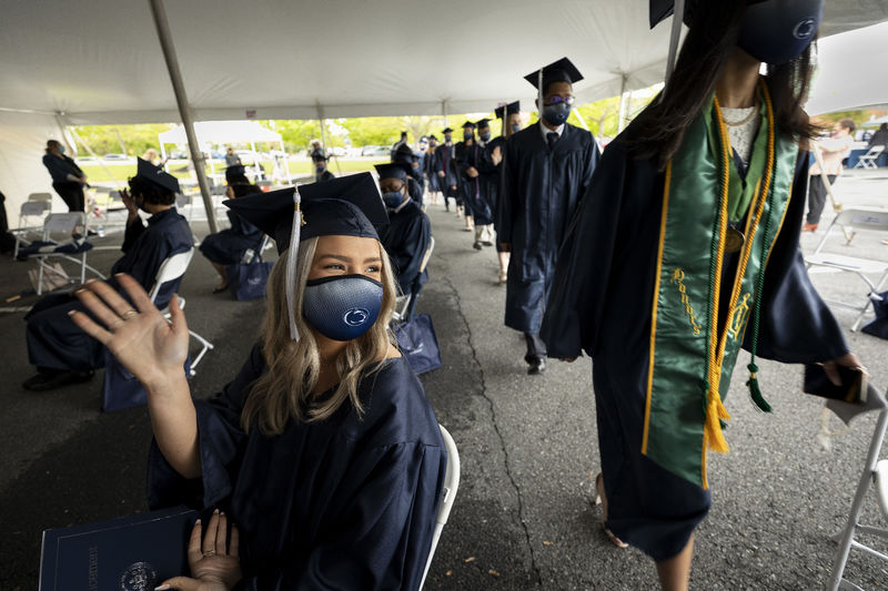 masked graduates walked into tent