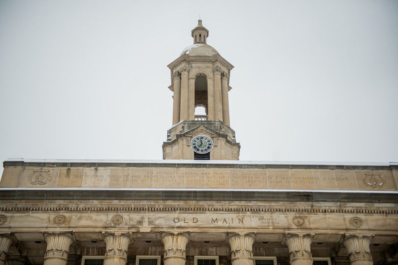 Tower of campus building with grey skies in background.