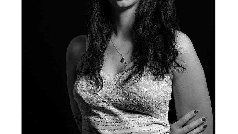 photograph of woman in clothing with writing on it