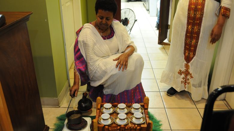 Woman making Ethiopian coffee