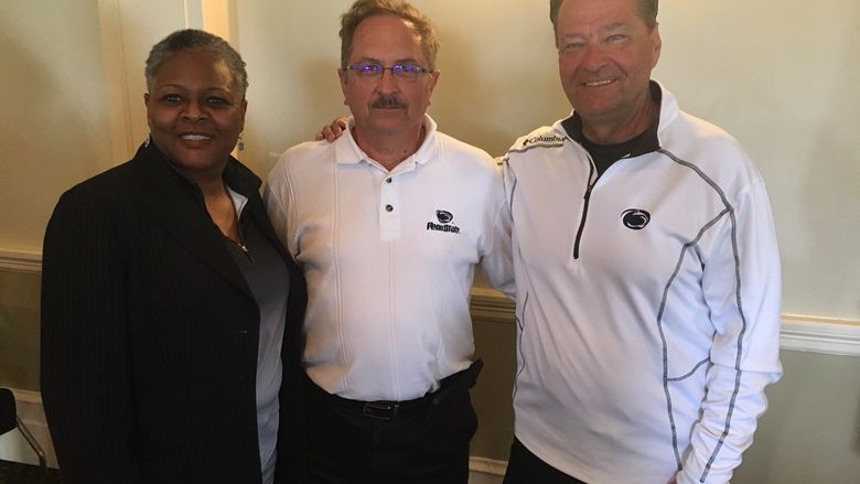 three people smiling at camera