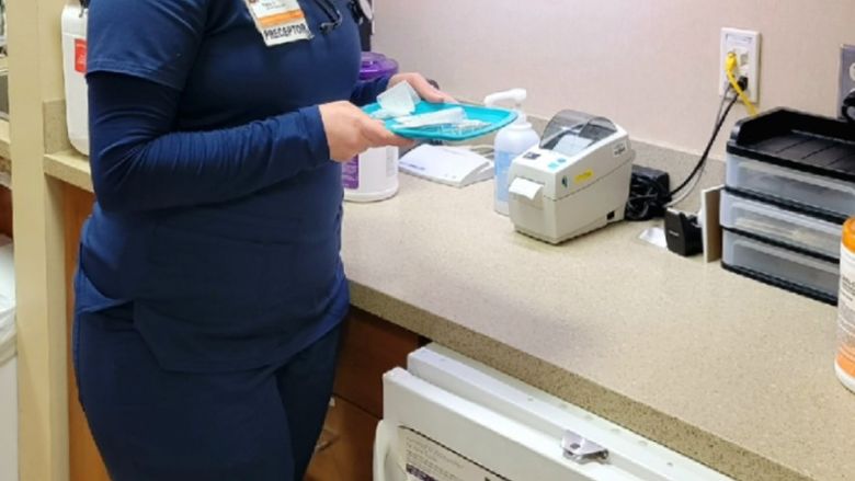 Taylor Argeson stands in examination room 