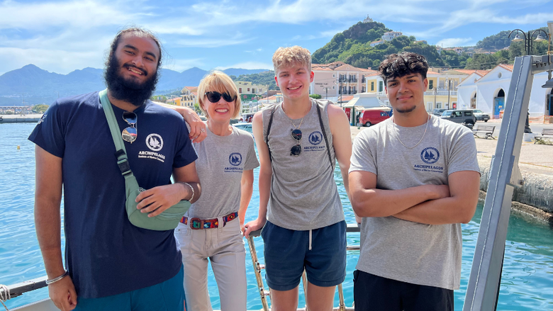 students smile in front of the Agean Sea in Greece 