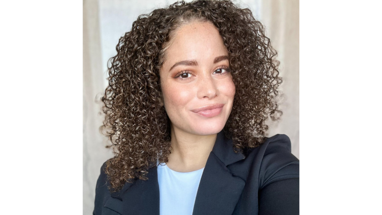 a headshot of a woman in a blazer smiling 