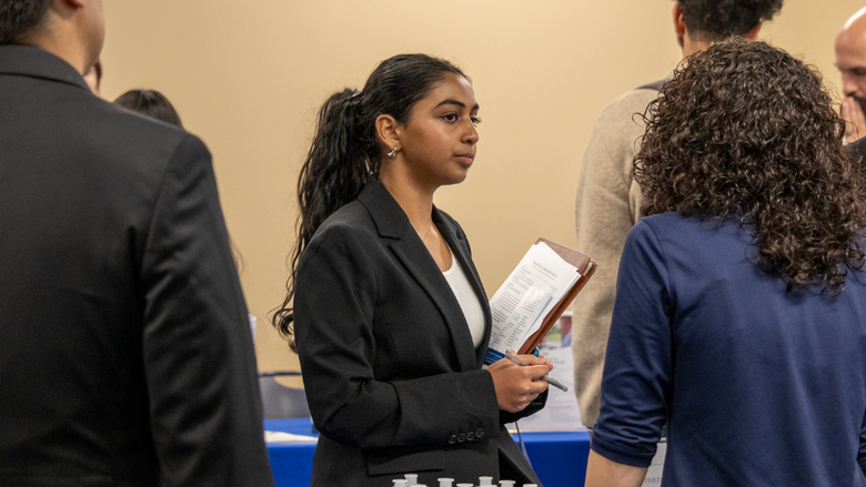 a female student speaking with an employer 