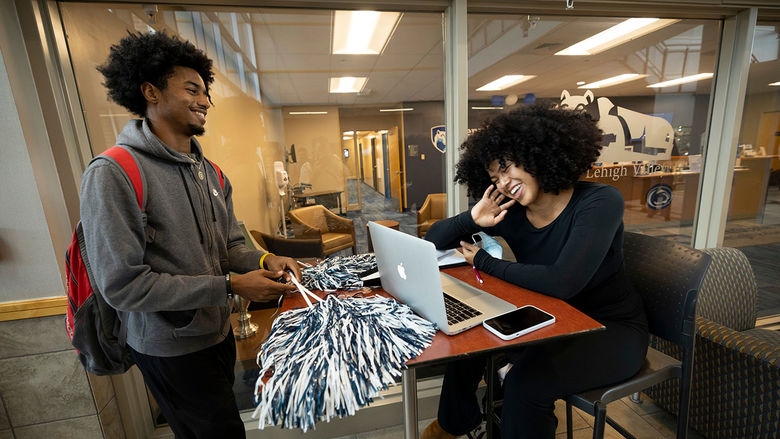 2 students laughing