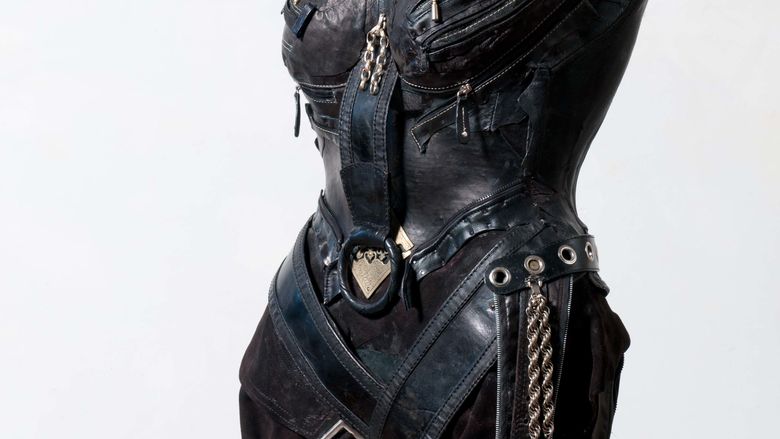 Sculpture of a torso dressed in leather armour.