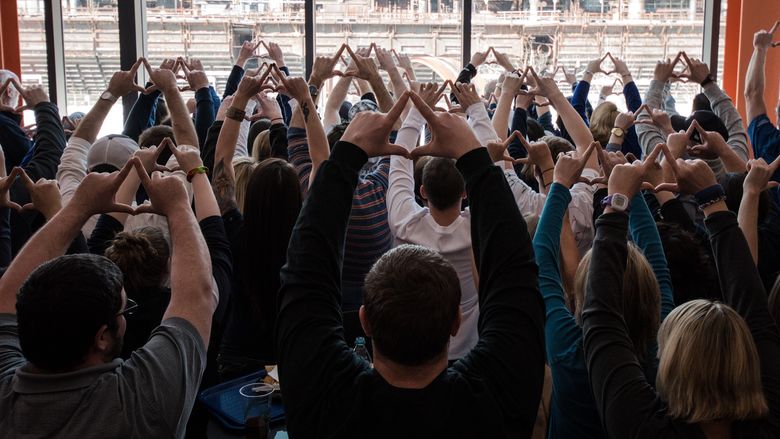 Group of people put their hands up in diamonds shape