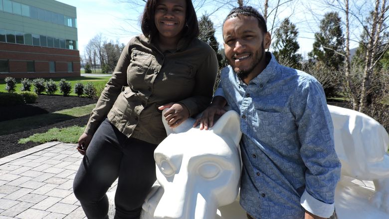 Two student athletes posing near Lion Shrine