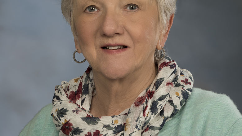 head shot of woman with scarf