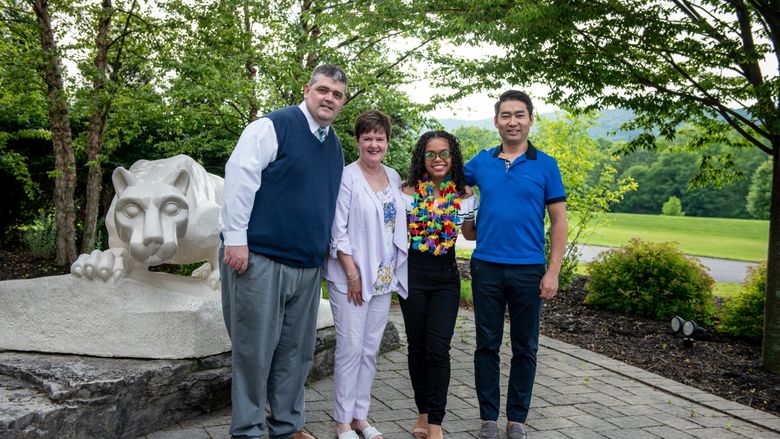four people in front Nittany Lion