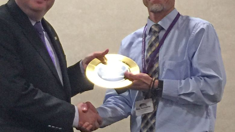a man being presented an award