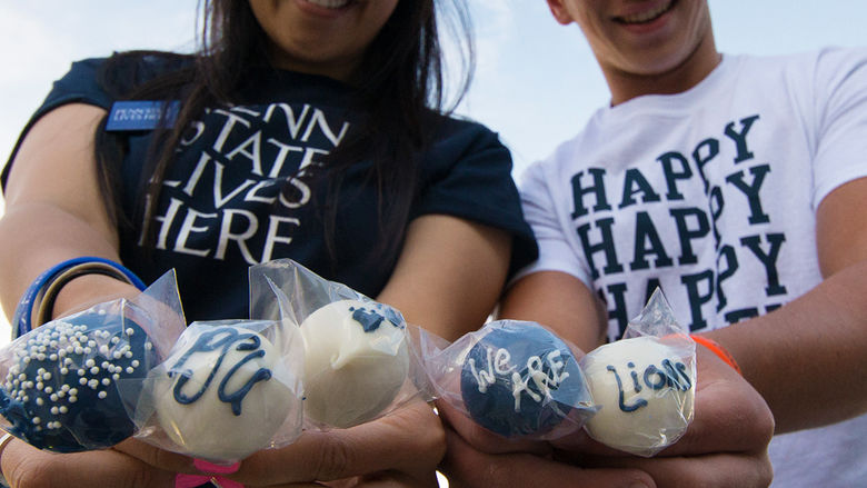 students holding lollipops