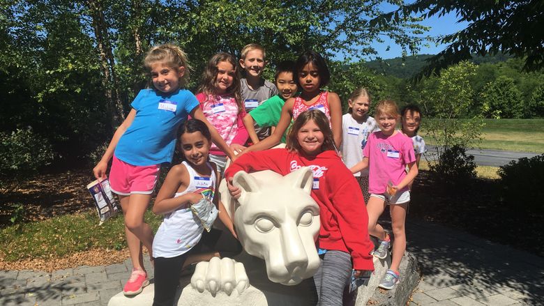 students in the summer youth camps posing at the lion shrine